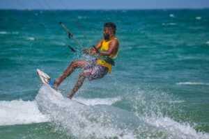 An adult kitesurfing on the ocean waves in Kalpitiya, Sri Lanka.