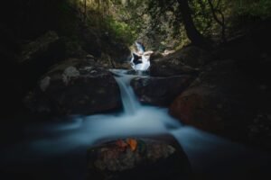 A serene and lush waterfall in the Belihuloya forest, Sabaragamuwa Province, Sri Lanka.