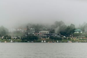 Serene misty landscape showcasing the lakefront in Nuwara Eliya, Sri Lanka.
